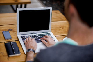 Featured image: business guy on laptop.jpg - No Painting Required for a Painting Franchise