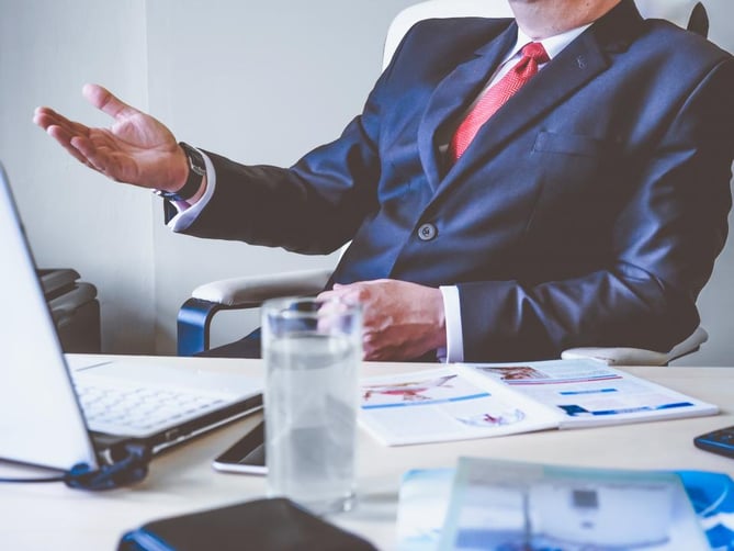Featured image: business man talking.jpg - Recruitment and Retention Strategies for Your Business