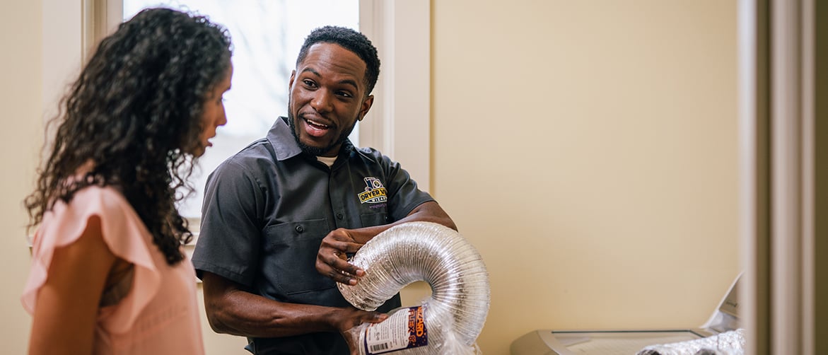 Featured image: Dryer Vent Wizard technician with a client. - Investing in Dryer Vent Cleaning for 2023 and Beyond