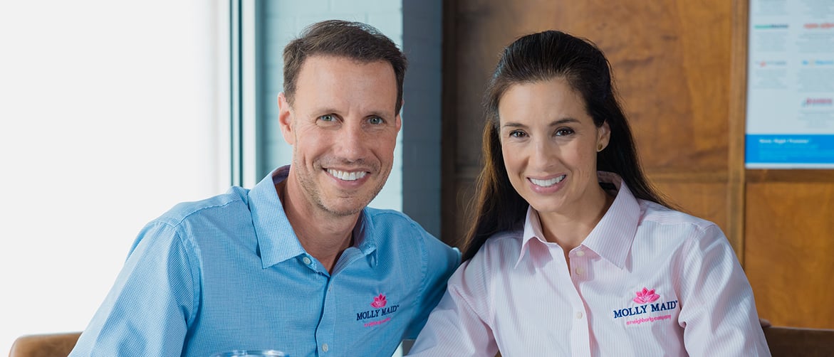 Featured image: Two Molly Maid franchise owners smiling. - Dusting off Your Dreams: Why a Residential Cleaning Business is a Smart Investment