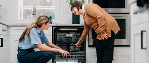 Featured image: Mr. Appliance technician helps client with dishwasher. - Appliance Repair Marketing Tips to Generate More Leads