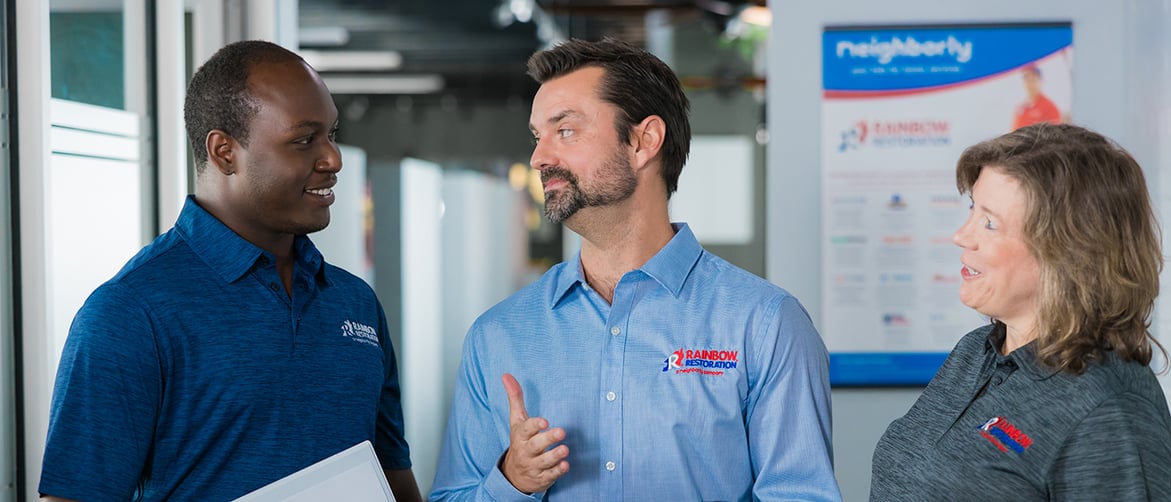 Featured image: Rainbow Restoration owner speaking to team members. - How to Start a Restoration Business | Neighborly