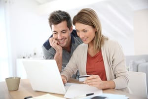 Featured image: Couple at a computer - How to Get Customer Feedback and Why It's Important
