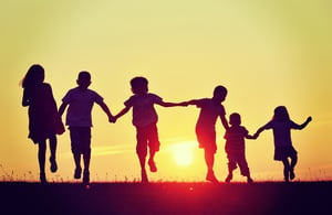 Family running into the sun. - Is Hiring Family a Good Idea?