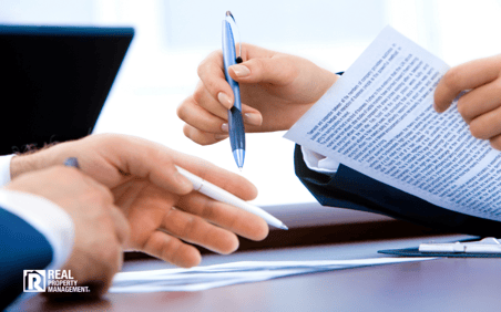 Close up of man's and woman's hands reviewing a franchise agreement Close up of man's and woman's hands reviewing a franchise agreement