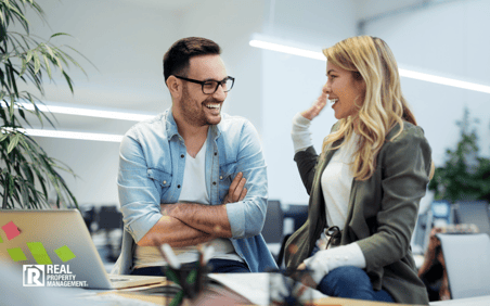 Happy man and woman sitting in office
