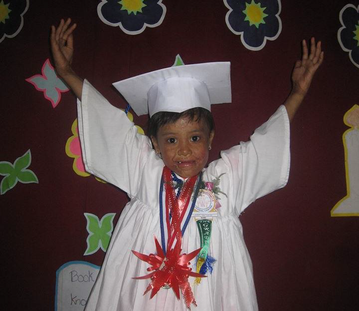 Child wearing a cap and gown