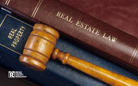 Two books - Real Property and Real Estate Law. Gavel on top of books. 