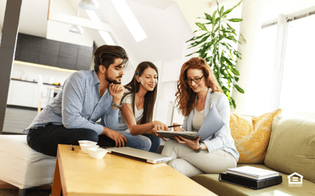 Couple with woman reviewing documents in a living room