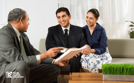 Man talking to couple in living room