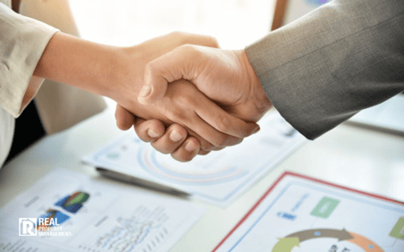 Man and woman shaking hands in business setting