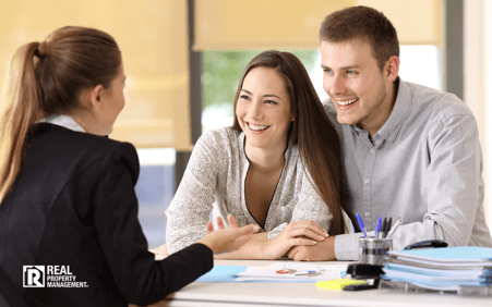 Woman with couple at business meeting