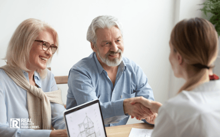 Woman with elderly couple at a business meeting