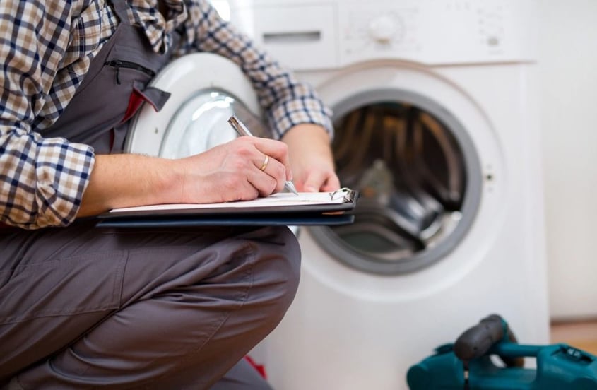 technician taking notes near dryer