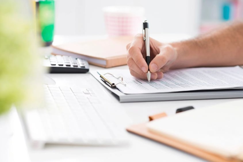 filling out forms on a clipboard