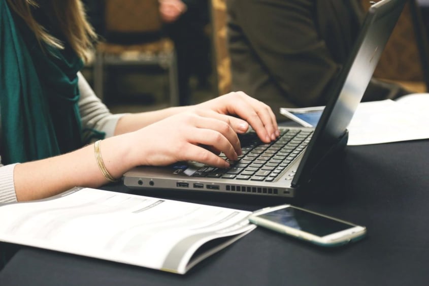 woman typing on laptop computer