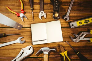 Featured image: Tools on a desk - Top 5 Ways to Keep Good Techs